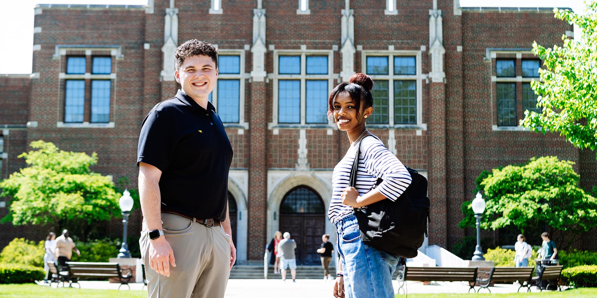 Male And Female Standing In Front Of Mees